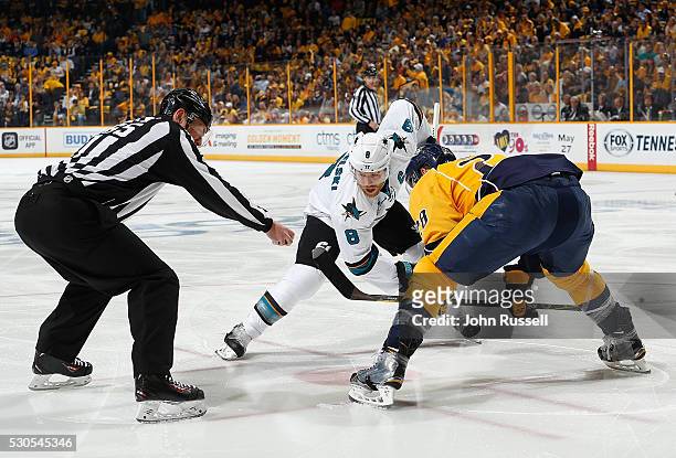 Linesman Pierre Racicot drops the puck between Joe Pavelski of the San Jose Sharks and Paul Gaustad of the Nashville Predators in Game Three of the...