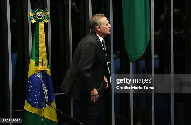 Brazilian Senate President Renan Calheiros walks past the Brazilian flag before the start of a special session in the Brazilian Senate to vote on...