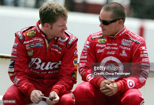 Dale Earnhardt Jr., left, driver of the Budwiser Chevrolet talks with Casey Mears driver of the Ganassi Racing Target Dodge as they prepare to...