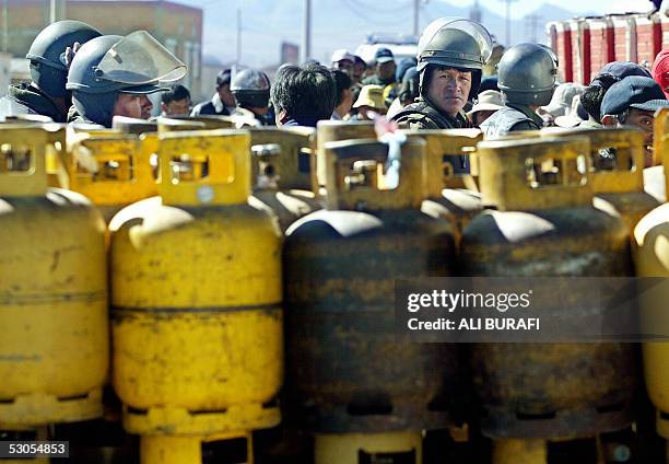 Military policemen guard the gas bottles supply in El Alto, Bolivia, 11 June 2005, after weeks of shortage due to a three-week uprising by...