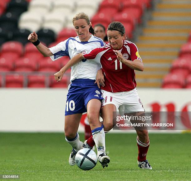 Finland's Anne-Kaisa Rantanen vies for the ball with Denmark's Merete Pedersen during their Group match of the European Women's Championship football...