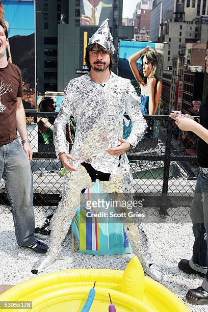 Dave Grohl of the Foo Fighters is wrapped in aluminum foil during MTV2's "24 Hours Of Foo" outside the MTV Times Square Studios June 11, 2005 in New...