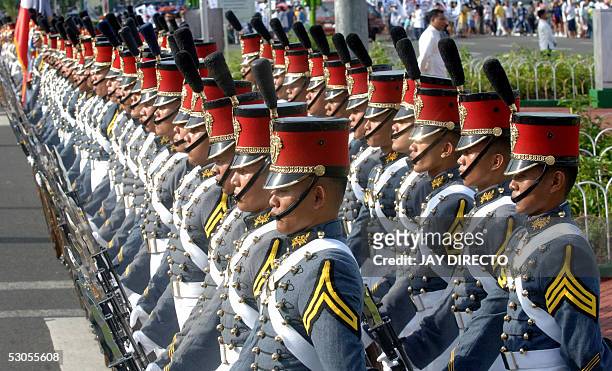 Philippine military academy cadets stand guard before the celebration of the Philippine's 107th Independence Day in Manila, 12 June 2005. President...