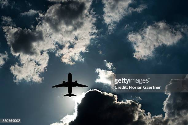 The silhouette of a plane is captured on May 11, 2016 in Berlin, Germany.