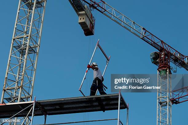 Man works on a scaffolding on May 11, 2016 in Berlin, Germany.