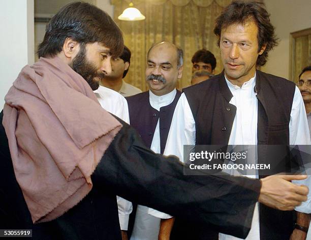 Pakistani cricketer-turned-politician Imran Khan looks on as the visiting Indian head of the pro-independence Jammu and Kashmir Liberation Front ,...