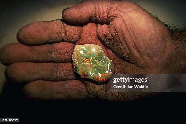 Opal miner John Shane holds a finished opal June 12, 2005 in the outback mining town of Coober Pedy, Australia. Australia supplies 95 percent of the...