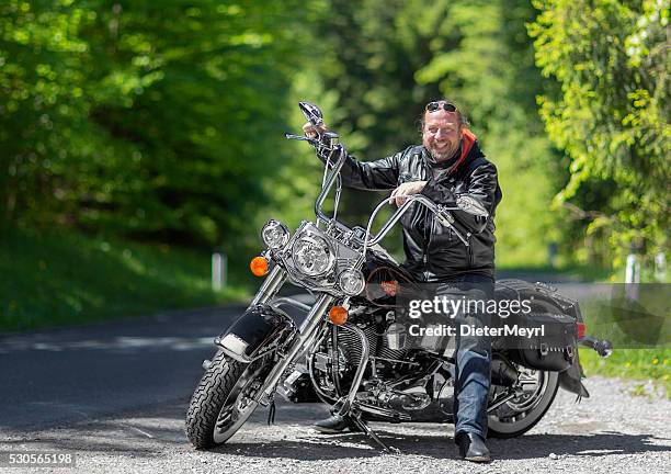 satisfied harley davidson rider at springtime - harley davidson stockfoto's en -beelden