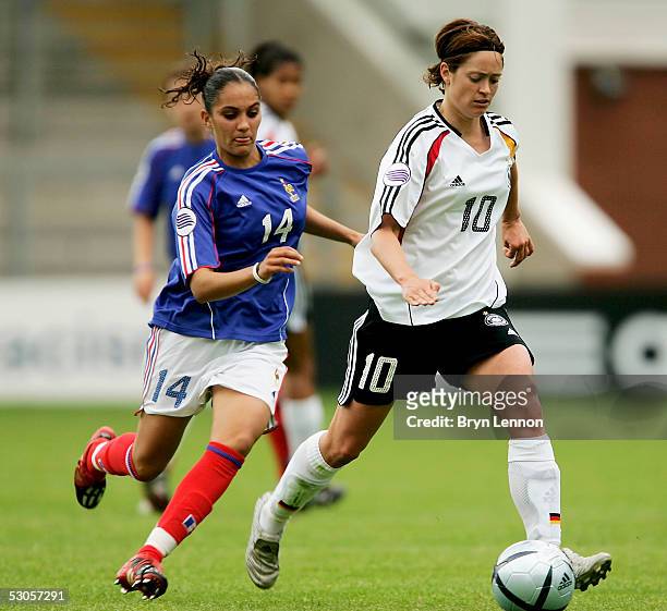 Renate Lingor of Germany slips past Louisa Necib of France during the Women's UEFA European Championship 2005 Group B match between Germany and...