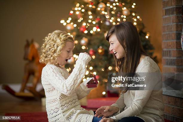 mother giving her daughter a gift - necklace stock pictures, royalty-free photos & images