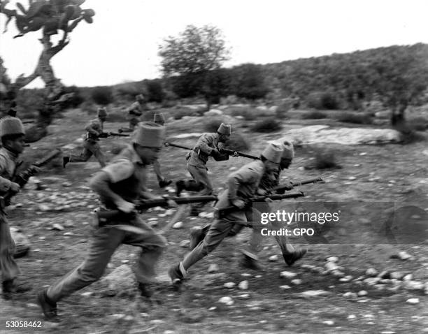 Members of the Jewish settlement police advance against Arab marauders December 13, 1938 near Kibbutz Ramat David, during the British Mandate of...