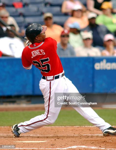 Andruw Jones of the Atlanta Braves hits a two-run home run in the fifth inning against the Oakland Athletics at Turner Field on June 12, 2005 in...