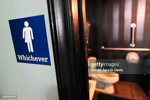 Gender neutral sign is posted outside a bathrooms at Oval Park Grill on May 11, 2016 in Durham, North Carolina. Debate over transgender bathroom...