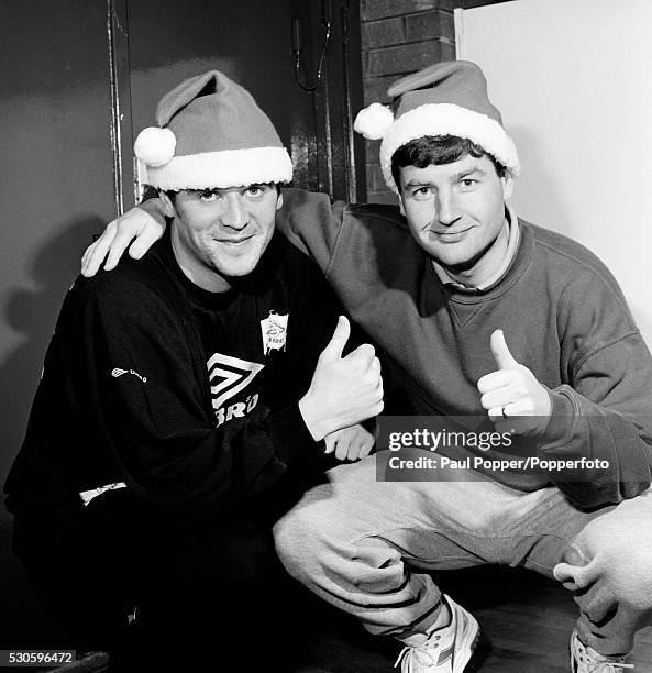 Manchester United footballers Roy Keane and Denis Irwin are in the mood for Christmas, circa December 1994.