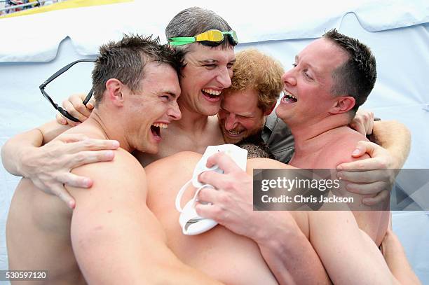 Prince Harry celebrates with UK Armed Forces Team Captain David Wiseman and the 4 x 50m Relay team who won gold at the swimming pool during the...