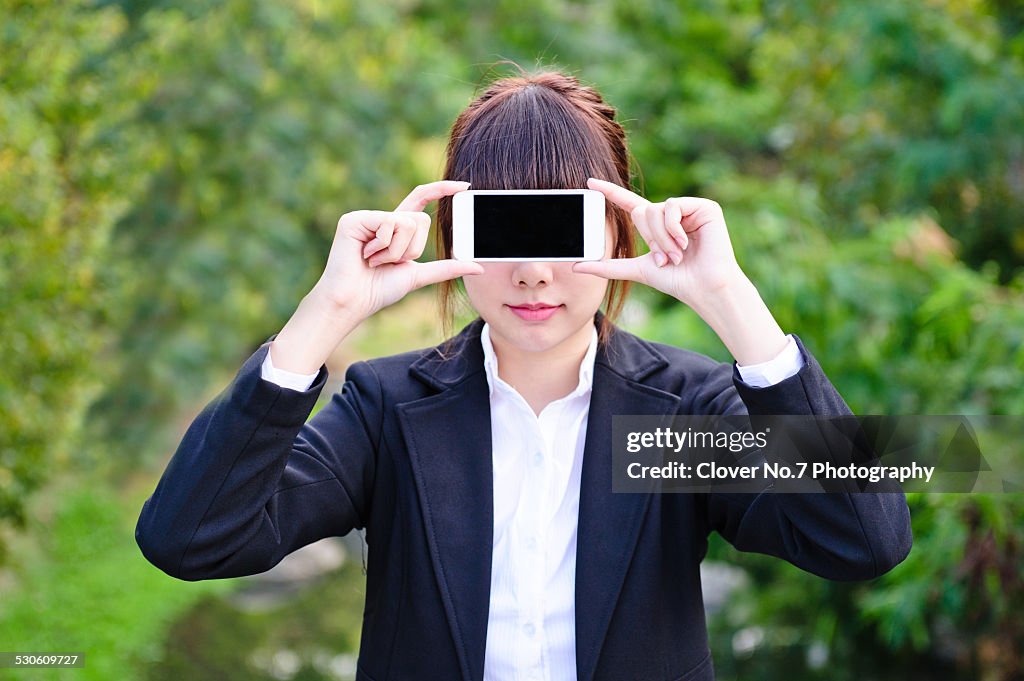 Business woman holding a smart phone