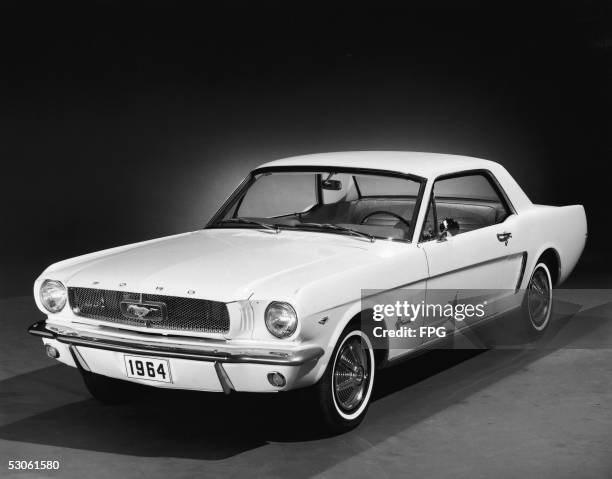 Promotional studio shot of a 1964 Ford Mustang, 1964. This first series of the popular pony car is generally referred to as '1964 1/2 Mustangs,'...