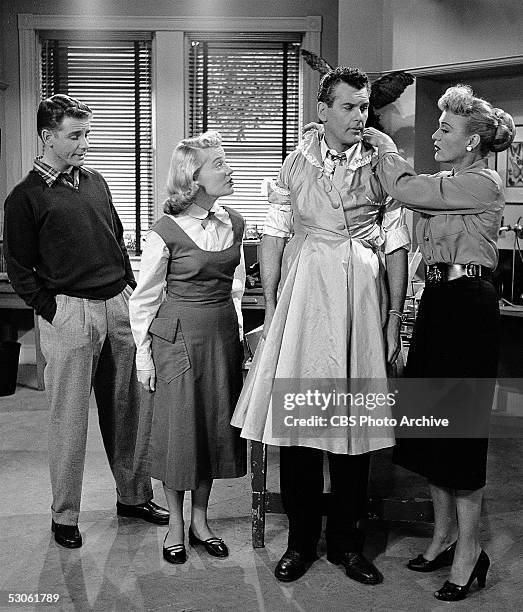 American actress Eve Arden adjusts a dress on actor Robert Rockwell as actor Richard Crenna and actress Gloria McMillan , look on and comment in a...