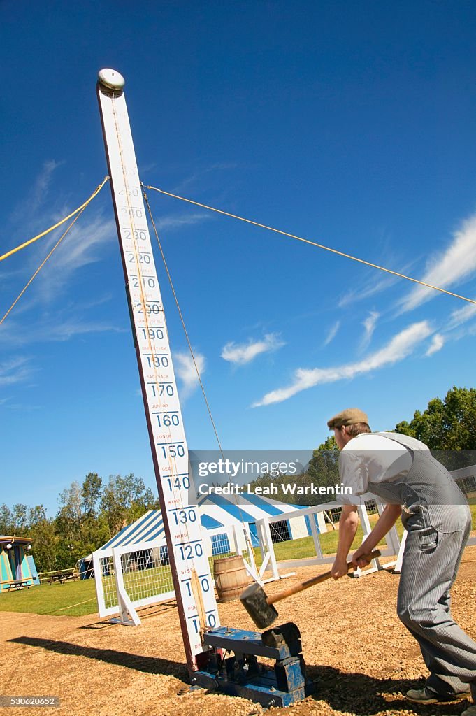 Man Hitting the High Striker