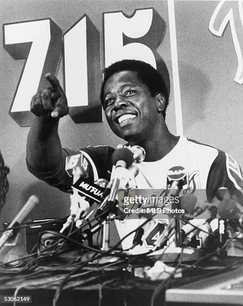 Hank Aaron of the Atlanta Braves talks during a press conference after he hit his 715th career home run on April 8, 1974 against the Los Angeles...