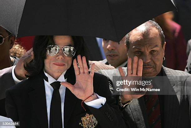 Michael Jackson and his father Joe Jackson wave to fans as they exit the court after hearing the jury declare Not Guilty on all counts in the Michael...