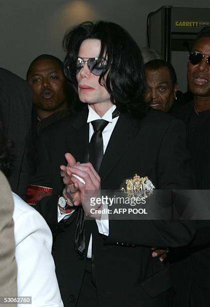 Michael Jackson leaves Santa Barbara County Courthouse clutching a tissue after a jury acquitted the US pop star on all counts in his child...
