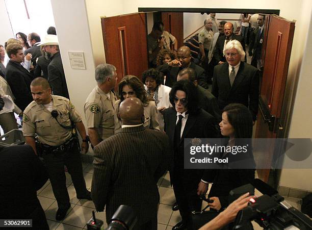 Singer Michael Jackson and defense attorneys Susan Yu , Thomas Mesereau Jr and Robert M. Sanger leave the courtroom after the jury in his child...