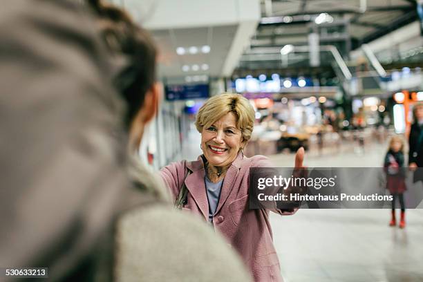 grandma welcoming young traveller - arrival hug stock pictures, royalty-free photos & images