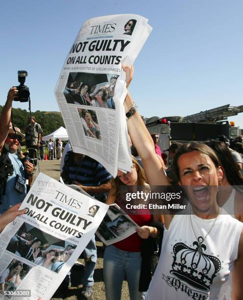 Michael Jackson fan, Laureen Rocks of France, reacts as she holds a special edition of the Santa Maria Times newspaper outside Jackson's Neverland...