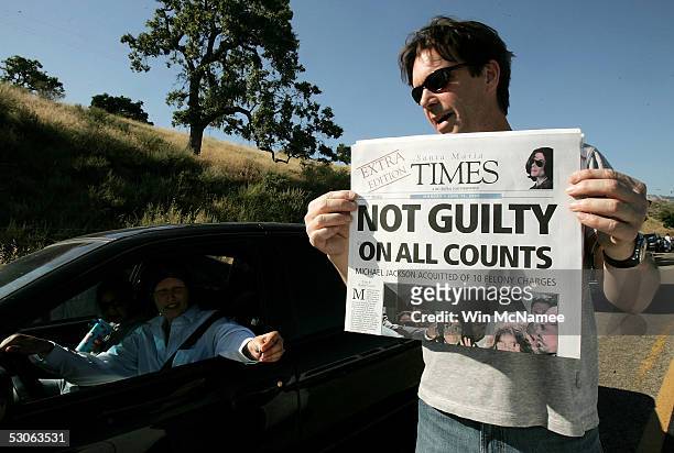 Steve Cochran sells early editions of a newspaper highlighting the verdict in the Michael Jackson trial outside Jackson's Neverland Ranch June 13,...