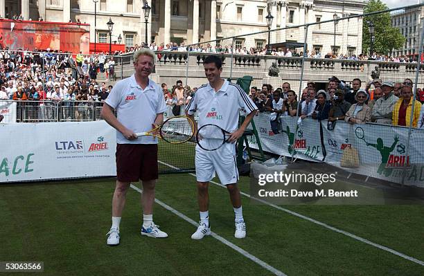 Tennis players Tim Henman and Boris Becker participate in the Ariel Celebrity Tennis Match held in Trafalgar Square June 13, 2005 in London, England.