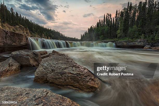 the trout river flows over sambaa deh falls in sambaa deh territorial park; northwest territories, canada - northwest territories stock pictures, royalty-free photos & images