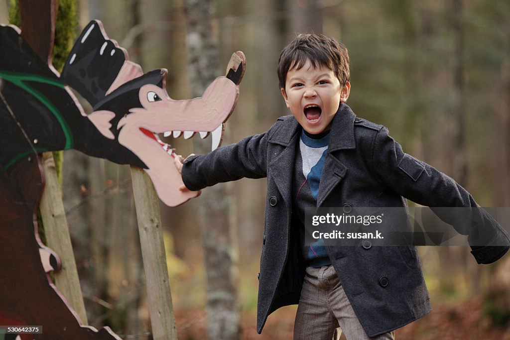 Boy screams pretending to be bitten by big wolf