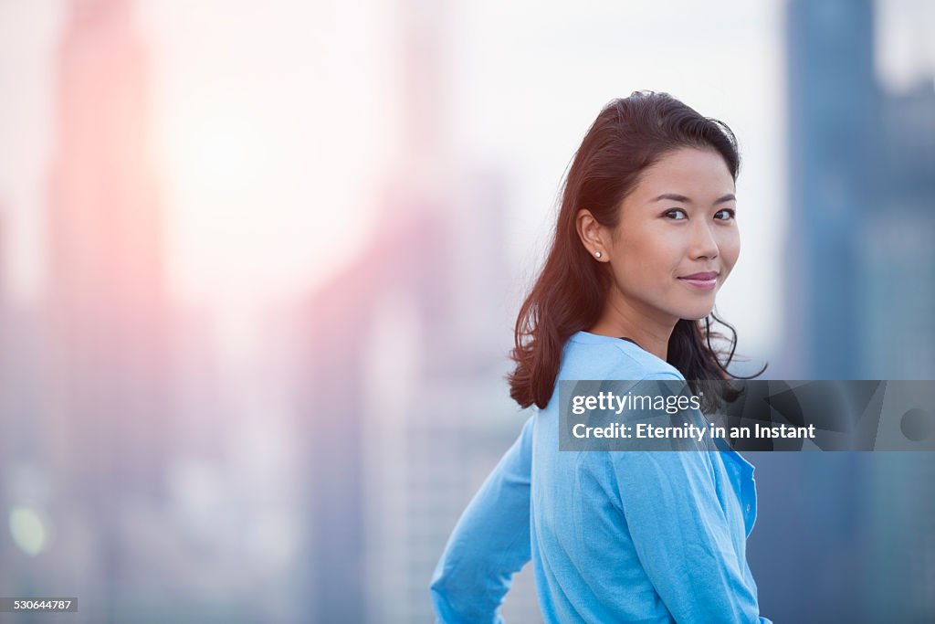 Asian woman smiling during sunset