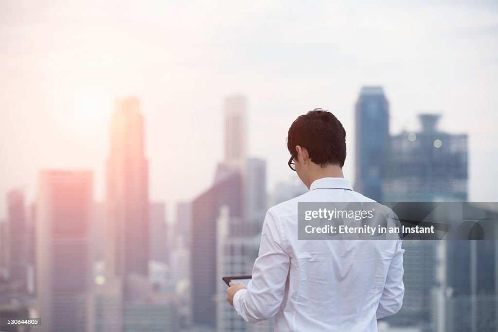 Rear view of young man on a tablet