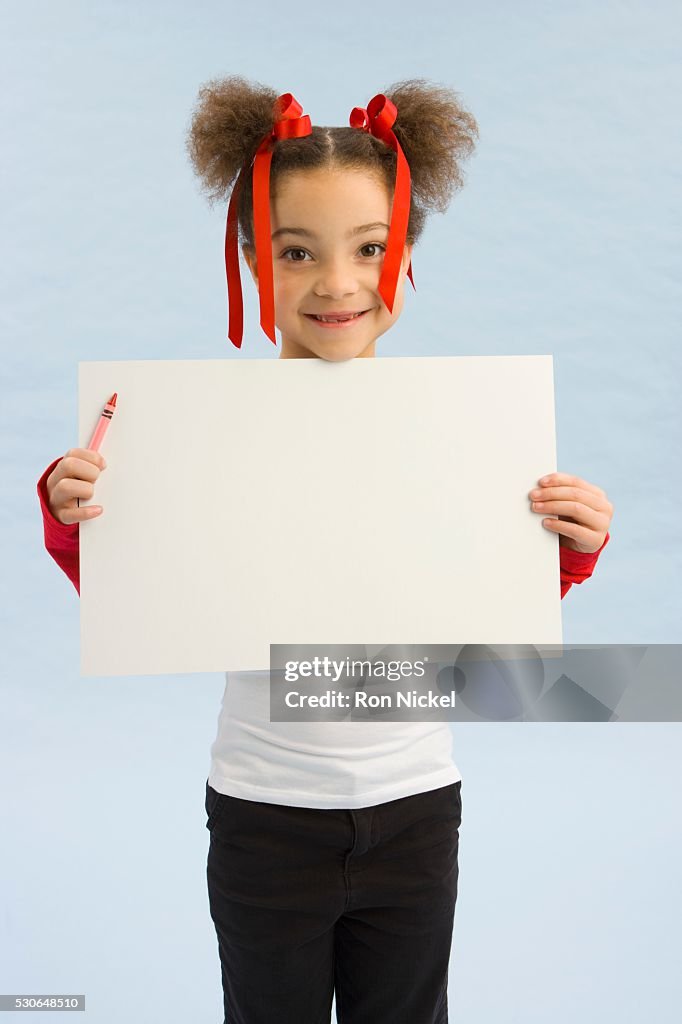 Girl holding up a book