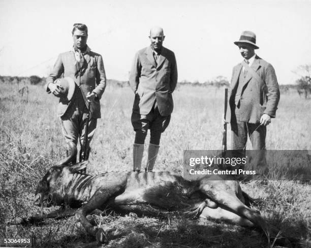 The Prince of Wales , later King Edward VIII, with the wildebeest which he shot at the Central Estates in Bulawayo, during a hunting trip to southern...