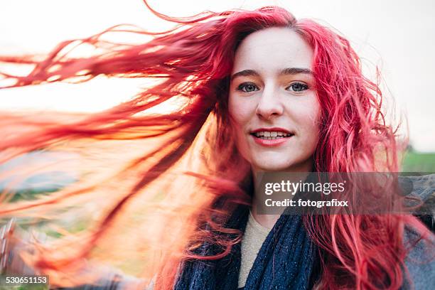 portrait of a redhead teenage girl with flinging hair - dyed red hair stock pictures, royalty-free photos & images