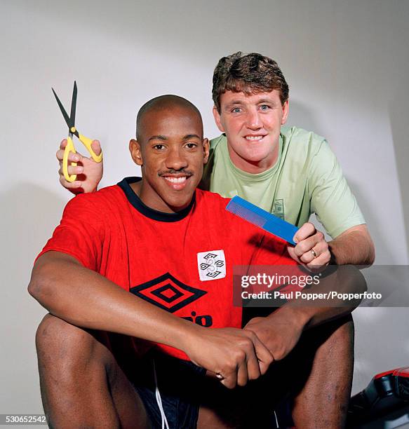 Manchester United striker Dion Dublin with Steve Bruce, who is too late to give his team-mate a haircut, circa 1993.