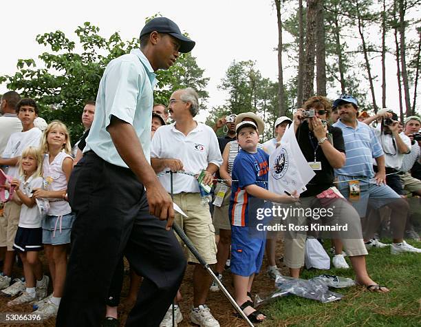 Tiger Woods makes his way past the crowd to the 11th tee during practice prior to the start of the U.S. Open at Pinehurst Resort June 14, 2005 in...