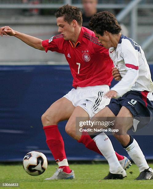 Michael Delura of Germany is tackled by Benny Feilhaber of USA during the FIFA World Youth Championship match between Germany and USA on June 14,...