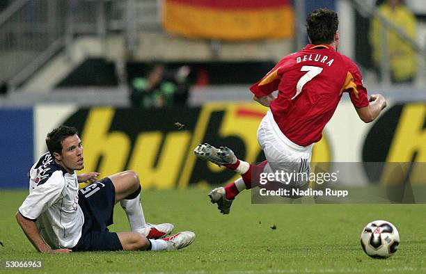 Michael Delura of Germany is tackled by Hunter Freeman of USA during the FIFA World Youth Championship match between Germany and USA on June 14, 2005...