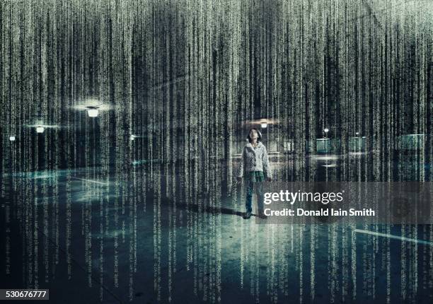 mixed race girl standing in parking lot under raining binary code - 數碼改善 個照片及圖片檔