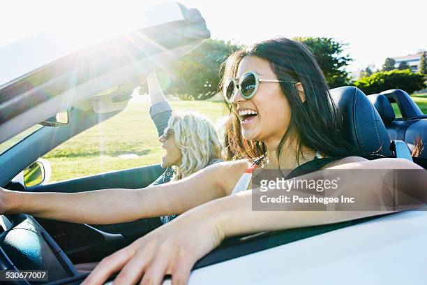 excited women driving convertible on road trip - hot blonde woman fotografías e imágenes de stock