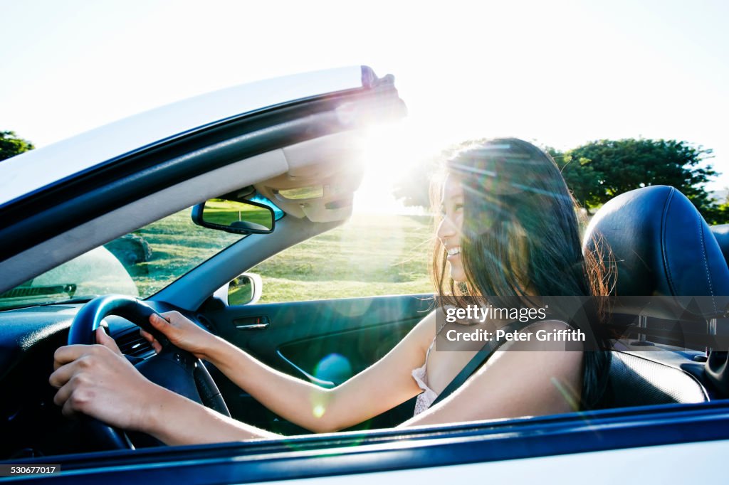 Chinese woman driving convertible