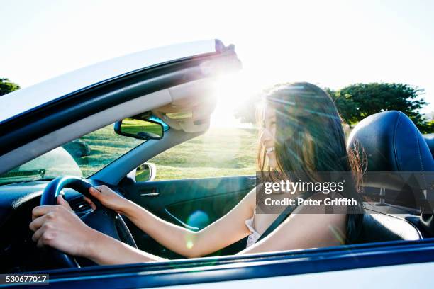 chinese woman driving convertible - chevrolet cabriolet stock pictures, royalty-free photos & images