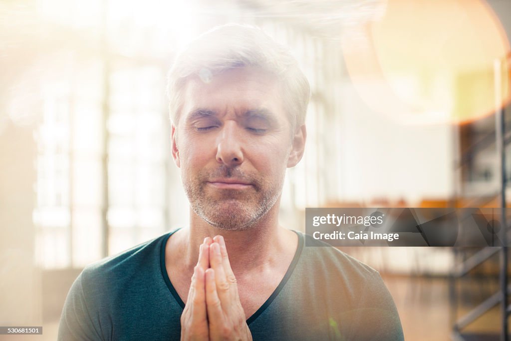 Close up of older man meditating