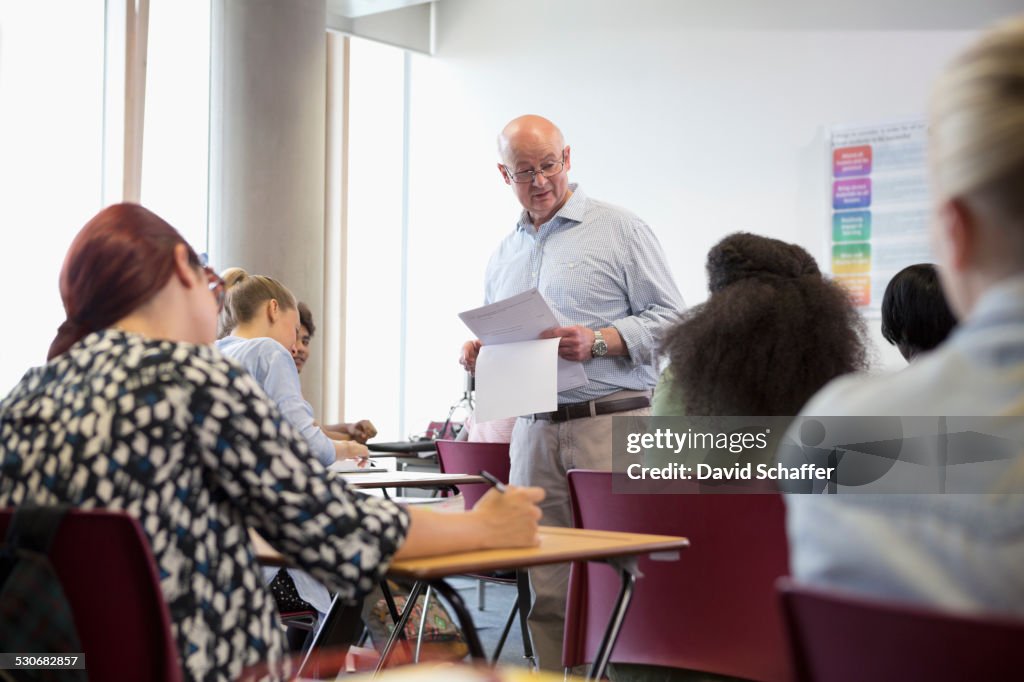 Professor giving exam results to university students