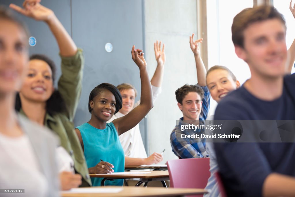 University students raising hands at seminar