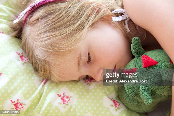 little girl taking a nap - alexandra dost stock-fotos und bilder